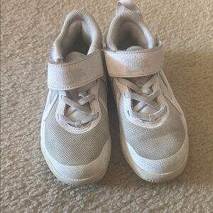 Kids white Nike shoes
